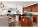 Open kitchen featuring cherry cabinets, island, and stainless steel appliances at 161 Fort Jackson Rd, Morrisville, NC 27560