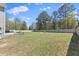 Overhead view of a large backyard with a fire pit, patio, privacy fence, and beautiful landscaping at 166 Old Field Loop Loop, Sanford, NC 27332