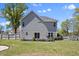 Backyard featuring lush green grass, manicured landscaping, a privacy fence, and a well-maintained lawn at 166 Old Field Loop Loop, Sanford, NC 27332
