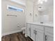 Bathroom features white cabinets, marble countertops, modern fixtures, and wood-look floors at 166 Old Field Loop Loop, Sanford, NC 27332