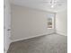 Well-lit bedroom with a window view, carpeted floor, ceiling fan, and closet at 166 Old Field Loop Loop, Sanford, NC 27332