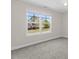 Well-lit bedroom with a large window showcasing neighborhood views and carpeted floors at 166 Old Field Loop Loop, Sanford, NC 27332