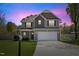 Charming two-story home with a well-manicured lawn and a two-car garage at 166 Old Field Loop Loop, Sanford, NC 27332