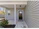 Inviting front porch with gray siding and black front door at 166 Old Field Loop Loop, Sanford, NC 27332
