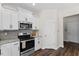 Kitchen features stainless appliances, granite counters, gray backsplash, and ample white cabinets at 166 Old Field Loop Loop, Sanford, NC 27332