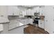 Kitchen boasts white cabinets, granite countertops, gray subway tile backsplash, and stainless appliances at 166 Old Field Loop Loop, Sanford, NC 27332