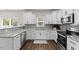 Updated kitchen with white cabinets, granite countertops, and stainless steel appliances at 166 Old Field Loop Loop, Sanford, NC 27332