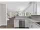 Open-concept kitchen flows into the living area with stainless steel appliances and granite countertops at 166 Old Field Loop Loop, Sanford, NC 27332