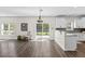 Bright living room with hardwood floors, backyard access, kitchen bar, and recessed lighting at 166 Old Field Loop Loop, Sanford, NC 27332