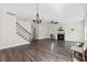Spacious living room featuring a cozy fireplace, wood floors, neutral walls, and a staircase at 166 Old Field Loop Loop, Sanford, NC 27332