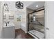 Sleek main bathroom with glass-enclosed shower, soaking tub, and contemporary lighting at 166 Old Field Loop Loop, Sanford, NC 27332