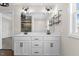 Modern main bathroom featuring a dual vanity with black fixtures and a large mirror at 166 Old Field Loop Loop, Sanford, NC 27332