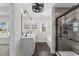 Lavish main bathroom with dual vanity, modern fixtures, a glass shower, and soaking tub at 166 Old Field Loop Loop, Sanford, NC 27332