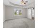 Spacious main bedroom with tray ceiling, ceiling fan, and barn door to ensuite bathroom at 166 Old Field Loop Loop, Sanford, NC 27332