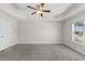 Bright main bedroom featuring a tray ceiling, ceiling fan, and a large window at 166 Old Field Loop Loop, Sanford, NC 27332