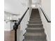 Beautiful staircase with dark handrails leading to the upper level and kitchen at 166 Old Field Loop Loop, Sanford, NC 27332