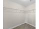 Spacious walk-in closet featuring ample storage with metal shelving and neutral carpeting at 166 Old Field Loop Loop, Sanford, NC 27332