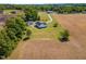 Expansive property featuring a charming house, outbuilding, and fields, all enhanced by lush greenery and a long, private drive at 175 Bill Avery Rd, Coats, NC 27521