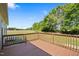 Inviting back deck with wooden railing provides a view of the expansive backyard and surrounding greenery at 175 Bill Avery Rd, Coats, NC 27521