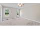 Bedroom with carpet, two windows, and a ceiling fan at 175 Bill Avery Rd, Coats, NC 27521