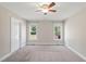 Bedroom with carpet, two windows, ceiling fan, and white walls at 175 Bill Avery Rd, Coats, NC 27521