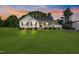 Beautiful single Gathering home on a large lot with mature trees and landscaping at sunset at 175 Bill Avery Rd, Coats, NC 27521