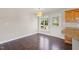 Eat-in-kitchen features wood floors, wood cabinets, and a back door entrance to a wooden deck at 175 Bill Avery Rd, Coats, NC 27521