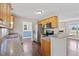 Well-lit kitchen with stainless steel appliances, granite countertops, and wood flooring throughout at 175 Bill Avery Rd, Coats, NC 27521