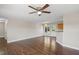 Spacious living room with hardwood floors leading into the kitchen and backyard access at 175 Bill Avery Rd, Coats, NC 27521