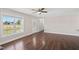 Bright living room featuring hardwood floors, ceiling fan, and front door access at 175 Bill Avery Rd, Coats, NC 27521