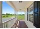 Covered porch with white columns overlooking a large yard at 175 Bill Avery Rd, Coats, NC 27521