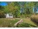 Spacious backyard featuring a white shed and abundant trees at 1804 N Alston Ave, Durham, NC 27701