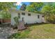 Home's backyard features a brick patio, a white exterior, and lush greenery at 1804 N Alston Ave, Durham, NC 27701