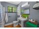 Updated bathroom featuring new fixtures, tiling, and natural light from the green-trimmed window at 1804 N Alston Ave, Durham, NC 27701