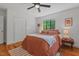Spacious bedroom with hardwood floors, ceiling fan, and large windows at 1804 N Alston Ave, Durham, NC 27701