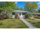 Beautiful home with a green lawn, trees, and a tidy walkway leading to the front door at 1804 N Alston Ave, Durham, NC 27701