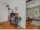 Inviting hallway showcasing hardwood floors, a charming bookcase, and views into the adjacent kitchen, blending style and functionality at 1804 N Alston Ave, Durham, NC 27701