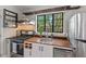 Cozy kitchen featuring butcher block countertops, modern stainless steel appliances, and natural light from the window at 1804 N Alston Ave, Durham, NC 27701