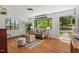Sunlit living room featuring gleaming hardwood floors, modern decor, and large windows offering views of the lush greenery at 1804 N Alston Ave, Durham, NC 27701