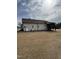 Rear exterior view with a propane tank, and a view of the screened-in porch at 194 Wood Valley Dr, Four Oaks, NC 27524