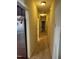 Bright hallway with multiple doors, with a refrigerator at the hallway's entrance at 194 Wood Valley Dr, Four Oaks, NC 27524