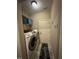 Functional laundry area featuring a washer, dryer, and extra storage shelving at 194 Wood Valley Dr, Four Oaks, NC 27524
