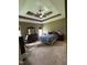 Spacious main bedroom with stylish trey ceiling, ceiling fan, neutral walls, and carpet at 194 Wood Valley Dr, Four Oaks, NC 27524