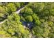 Aerial view of a cozy home nestled among lush, green trees, showcasing its private setting at 195 Nicks W Bnd, Pittsboro, NC 27312