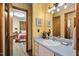 Well-lit bathroom with a vanity and sink, and the bedroom can be seen through the open door at 195 Nicks W Bnd, Pittsboro, NC 27312