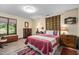 Bright bedroom with a large window, hardwood floors, and warm lighting at 195 Nicks W Bnd, Pittsboro, NC 27312