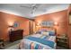 Comfortable bedroom with colorful bedding, wood-look floors and warm lighting at 195 Nicks W Bnd, Pittsboro, NC 27312