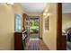 Inviting entryway with an open door, hardwood floors, a colorful rug, and charming decor at 195 Nicks W Bnd, Pittsboro, NC 27312