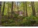 A-frame home with a spacious deck, nestled in a dense wooded landscape, offering privacy at 195 Nicks W Bnd, Pittsboro, NC 27312