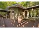 Wood paneled home exterior with a wooden deck surrounded by lush green trees at 195 Nicks W Bnd, Pittsboro, NC 27312